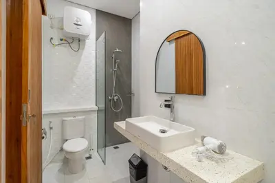 a bathroom with a sink and a toilet and a shower at Harmony A29-Peaceful 1BR Retreat in Seminyak