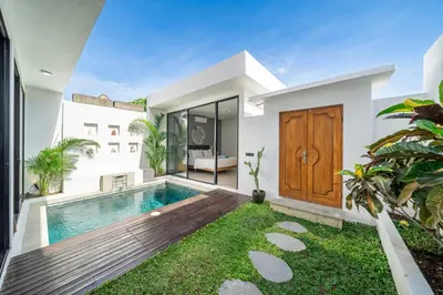 a villa with a swimming pool and a house at Harmony A29-Peaceful 1BR Retreat in Seminyak