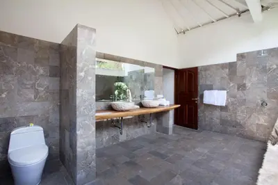 a bathroom with a toilet and a sink at Villa Alma in Legian