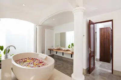 a bathroom with a large tub filled with sprinkles at Villa Amalia Walk To Legian Beach in Legian