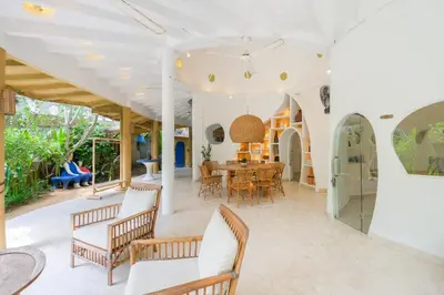 an open living room with a table and chairs at Mosaic Villa Sanur in Sanur