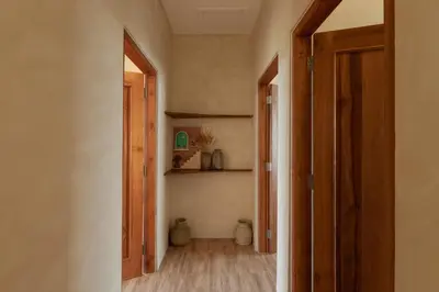 a hallway with an open door to a room at Casa Amani 3BR Terracotta Seminyak in Kerobokan