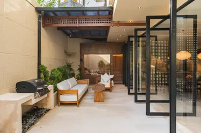 an outdoor patio with a couch and a table at Konoha Villa Umalas in Mantaak