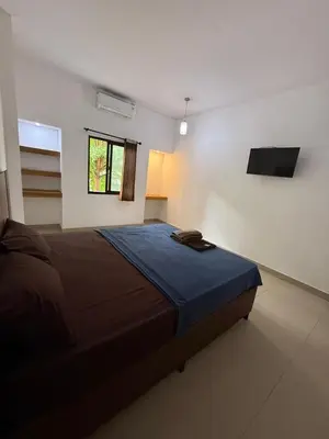 a bedroom with a large bed in a room at OKIE HOUSE HOTEL Poppies2 3 min from Kutabeach in Legian