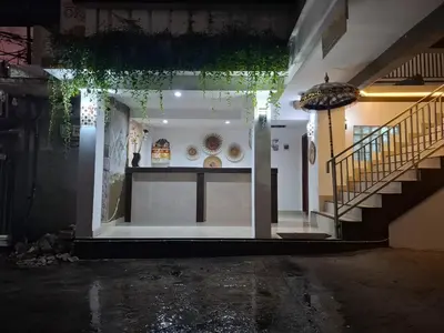 a room with a staircase and a building with lights at OKIE HOUSE HOTEL Poppies2 3 min from Kutabeach in Legian