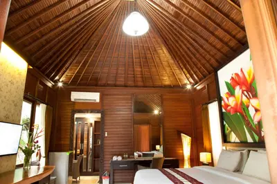 a bedroom with a bed and a wooden ceiling at Jepun Bali Hotel in Kuta