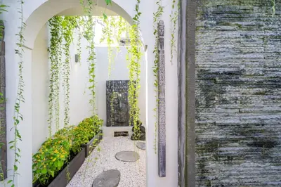 an archway leading to a garden with plants at luxury villa in seminyak in Seminyak