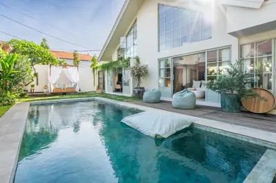 a swimming pool in front of a house at luxury villa in seminyak in Seminyak