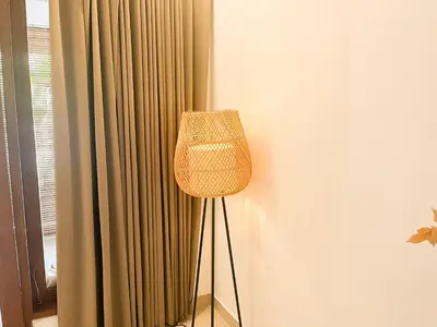 a lamp in a room next to a curtain at Villa Sayang 1 Seminyak in Seminyak