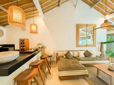 a living room with a couch and a table at Villa Sayang 1 Seminyak in Seminyak