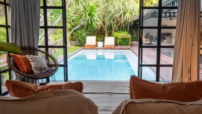 a view of a swimming pool from a living room at Villa Honeypot Berawa in Canggu