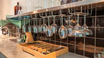a display of glass vases on a wall at Villa Honeypot Berawa in Canggu