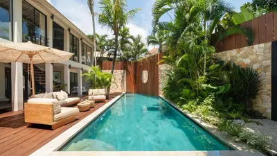 a swimming pool in the backyard of a house at Villa Dreamora by Villa Finder in Seminyak