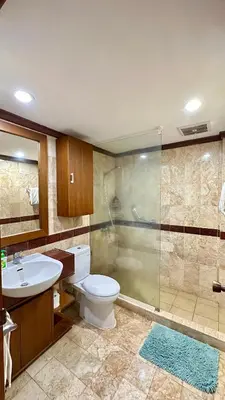 a bathroom with a toilet and a shower and a sink at Jayakarta Bali Apartments in Seminyak