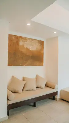 a couch in a room with a painting on the wall at Apartment Nata Umalas in Seminyak