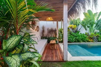 a backyard with a swimming pool and a house at NEW 3BR Fleur De Vie Tranquility Villa in Seminyak in Seminyak
