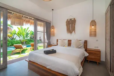 a bedroom with a bed and a large window at NEW 3BR Fleur De Vie Tranquility Villa in Seminyak in Seminyak