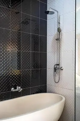 a bath tub in a bathroom with black tiles at Modern 2BR Villa in Seminyak Center - Private Pool in Seminyak