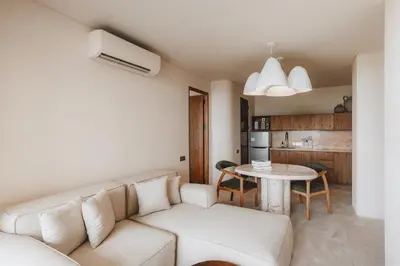 a living room with a white couch and a table at Suom Apartments and Villas Canggu in Canggu
