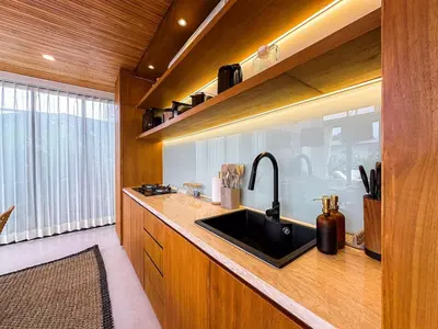 a kitchen with a sink and a counter top at Desa Hut - 2BR Tropical Ricefield Villa near Seminyak in Kerobokan