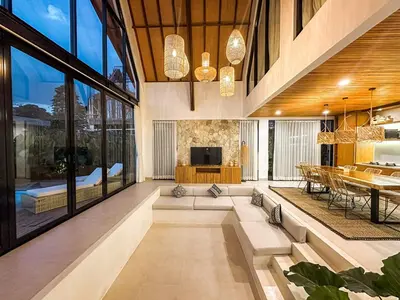 a large living room with a table and a television at Desa Hut - 2BR Tropical Ricefield Villa near Seminyak in Kerobokan