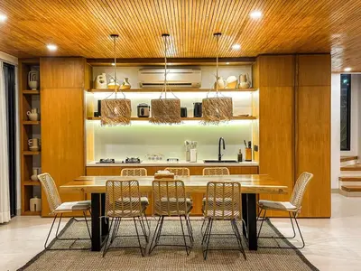 a dining room with a table and chairs at Desa Hut - 2BR Tropical Ricefield Villa near Seminyak in Kerobokan