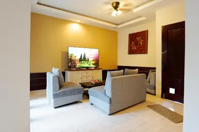 a living room with two chairs and a flat screen tv at 3 Bedrooms Villa with Pool WEST SANUR - Casa Del Lago in Sanur