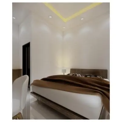 a bed in a room with a white wall at Moonlit Haven in Jimbaran