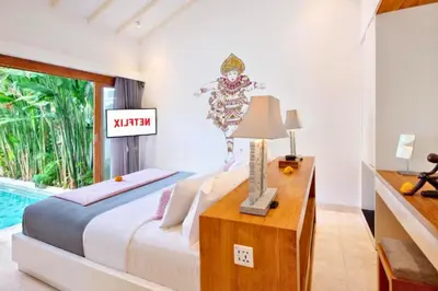 a bedroom with a bed and a sign that reads wrath at Daiva Comfortable 1 BR Private Pool Villa in Jimbaran