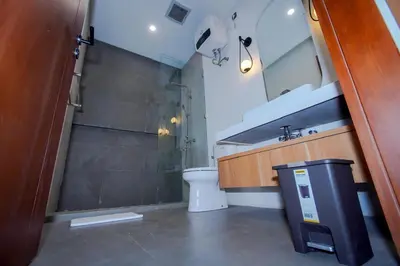 a bathroom with a toilet and a sink and a mirror at Rama Villa Umalas in Kerobokan