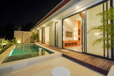 a house with a swimming pool in the backyard at Rama Villa Umalas in Kerobokan