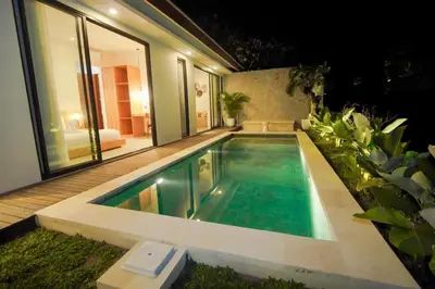 a swimming pool in the backyard of a house at Rama Villa Umalas in Kerobokan