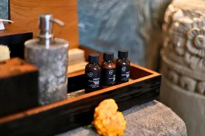 a wooden tray with three bottles of soap and a sink at Alena Cozy 1 BR Private Pool Villa With Lagoon Access in Seminyak