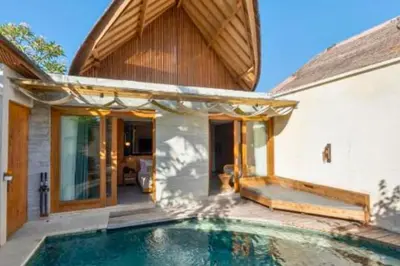 a swimming pool in front of a house at Alora Comfortable 1 BR Smart Pool Villa With Jacuzzi in Seminyak