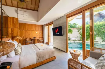 a hotel room with a bed and a pool at Alora Comfortable 1 BR Smart Pool Villa With Jacuzzi in Seminyak
