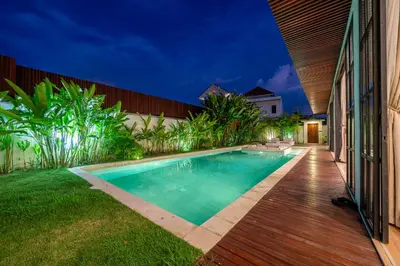a swimming pool in the backyard of a house at Palm Sugar 2-Chic 3BR Villa in Jimbaran with Pool&Garden in Jimbaran