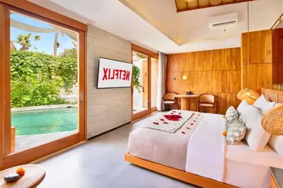 a bedroom with a large bed with a sign on the wall at Charity Stunning Grand 1 BR Pool Villa With Jacuzzi in Seminyak