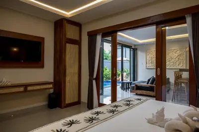 a bedroom with a bed and a sliding glass door at Villa Inges 3 Seminyak in Seminyak