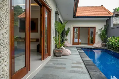 a house with a swimming pool next to a house at Villa Inges 3 Seminyak in Seminyak