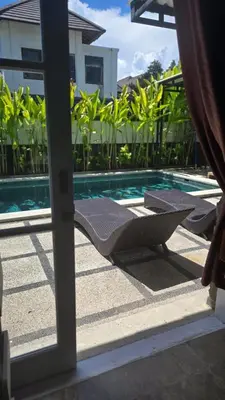 a view of a swimming pool through a sliding glass door at Villa Don Bose 8 in Jimbaran