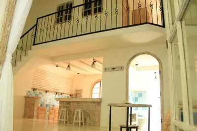 an archway leading into a room with a stone fireplace at M-Apartment in Badung