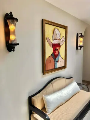 a painting of a man in a hat on a wall at Casa Mañana Villa Legian, Kuta in Legian