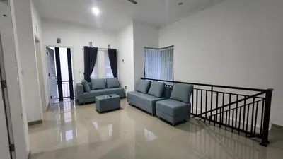a living room with two chairs and a couch at House of Tomolowicz in Jimbaran