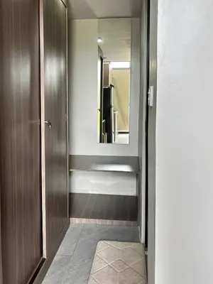 a hallway with a bathroom with a mirror at Olive Athena Guesthouse in Seminyak