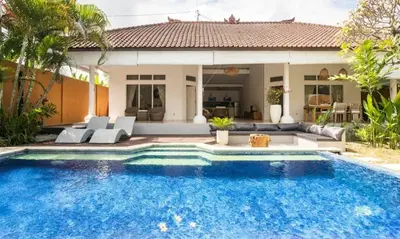 a swimming pool in front of a villa at Villa VITA in Seminyak
