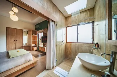 a bathroom with a bed and a tub and a sink at Azula Cozy Royal 2 BR Private Pool Villa With Jacuzzi in Legian