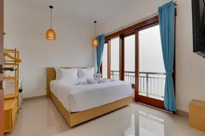 a bedroom with a bed and a large window at 3BR Villa Taman Seminyak 27 - Short Drive to Beach in Seminyak