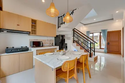 a kitchen and dining room with a table and chairs at 3BR Villa Taman Seminyak 27 - Short Drive to Beach in Seminyak