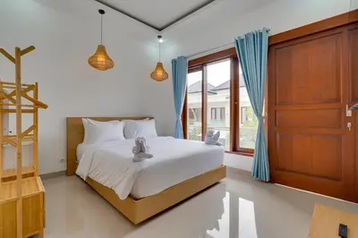 a bedroom with a bed and a large window at 3BR Villa Taman Seminyak 27 - Short Drive to Beach in Seminyak