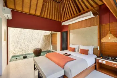 a bedroom with a bed and a bath tub at Bahira Lovely 1 BR Grand Pool Villa With Bathtub in Legian